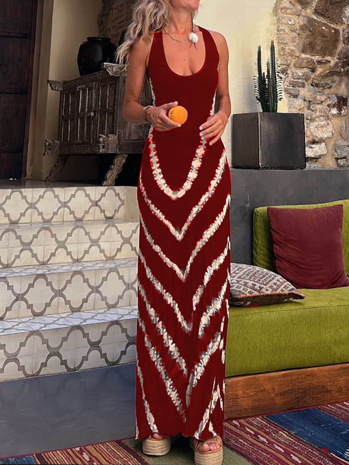 Vestido largo elástico con lazo y estampado de ondas de la marca Alessia Madrid, con diseño fluido y detalles en la cintura.